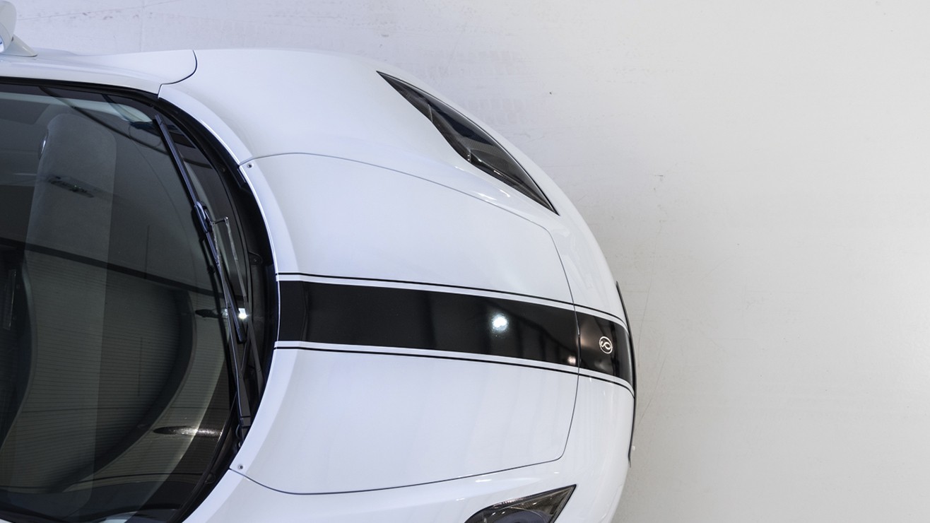 The bonnet of a luxury white and black sports car, as seen from above